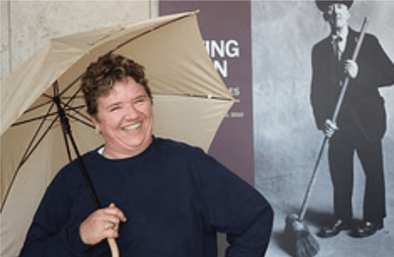 Woman under a tan umbrella