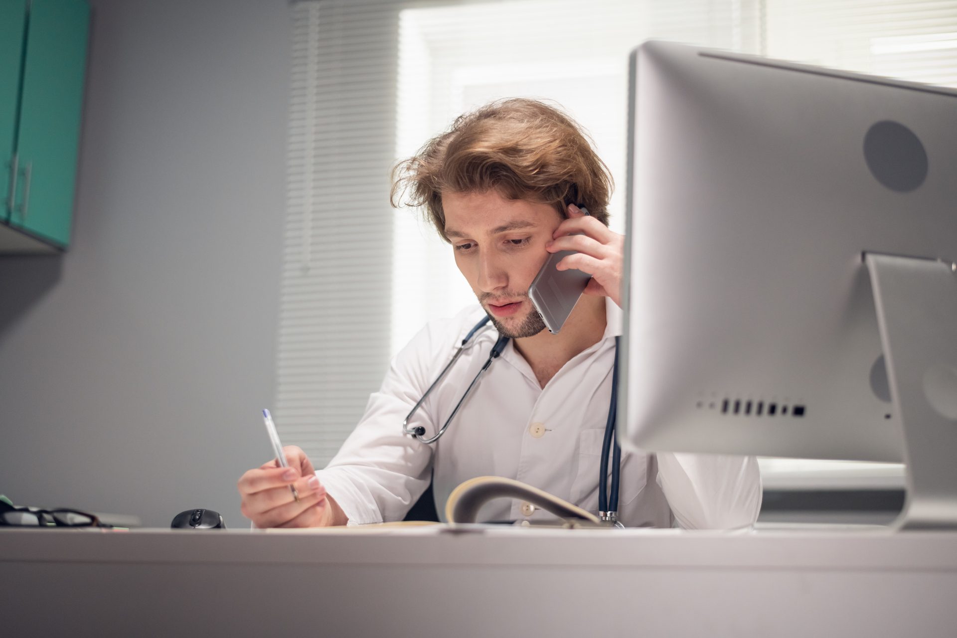 Doctor talking to his patient over the phone